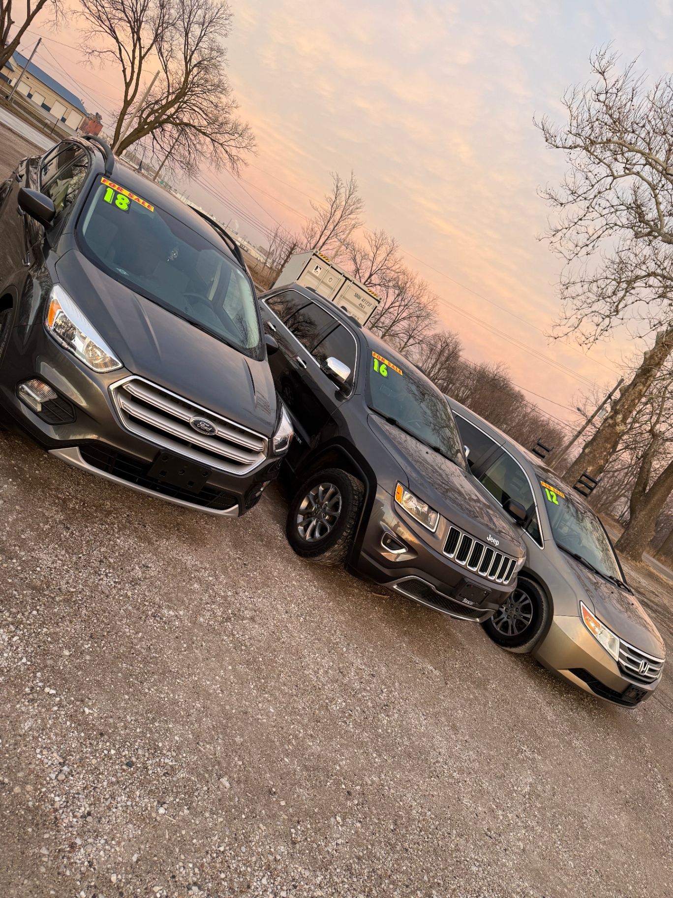 Vehicles on the lot at sunset